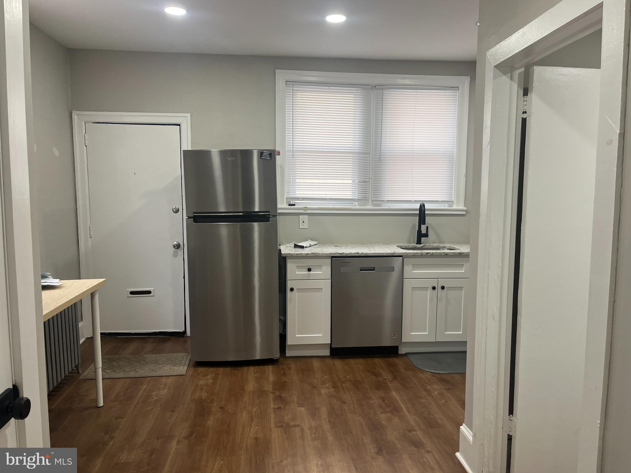 1251 East Fletcher Street, Unit 1R Philadelphia, PA 19125 - Photo 2 of 5 a kitchen with a refrigerator sink and cabinets