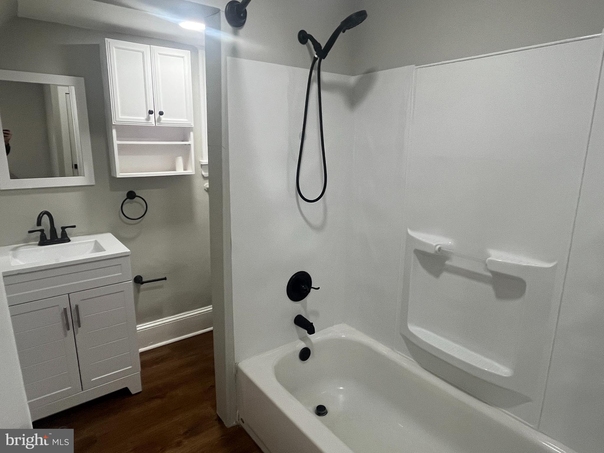 1251 East Fletcher Street, Unit 1R Philadelphia, PA 19125 - Photo 4 of 5 a bathroom with a tub sink a mirror and shower