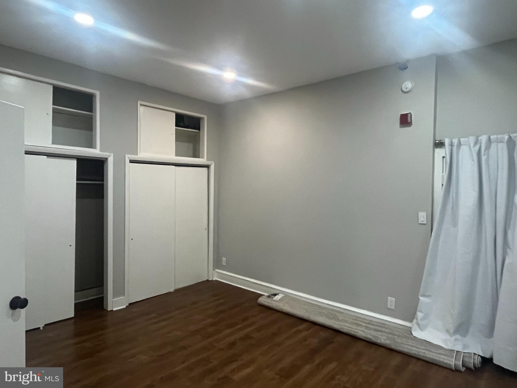 1251 East Fletcher Street, Unit 1R Philadelphia, PA 19125 - Photo 5 of 5 an empty room with wooden floor and a window