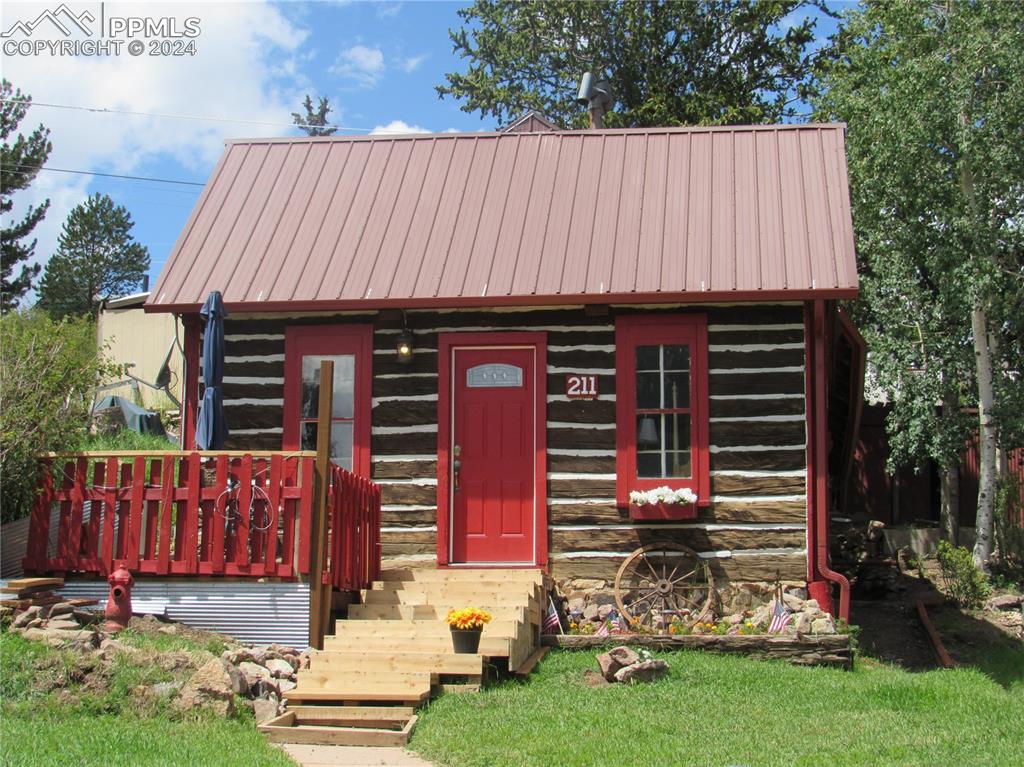 211 5th Street Victor, CO 80860 - Photo 1 of 22 a view of a small house with yard and sitting area