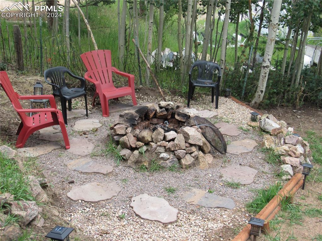 211 5th Street Victor, CO 80860 - Photo 13 of 22 a backyard of a house with table and chairs