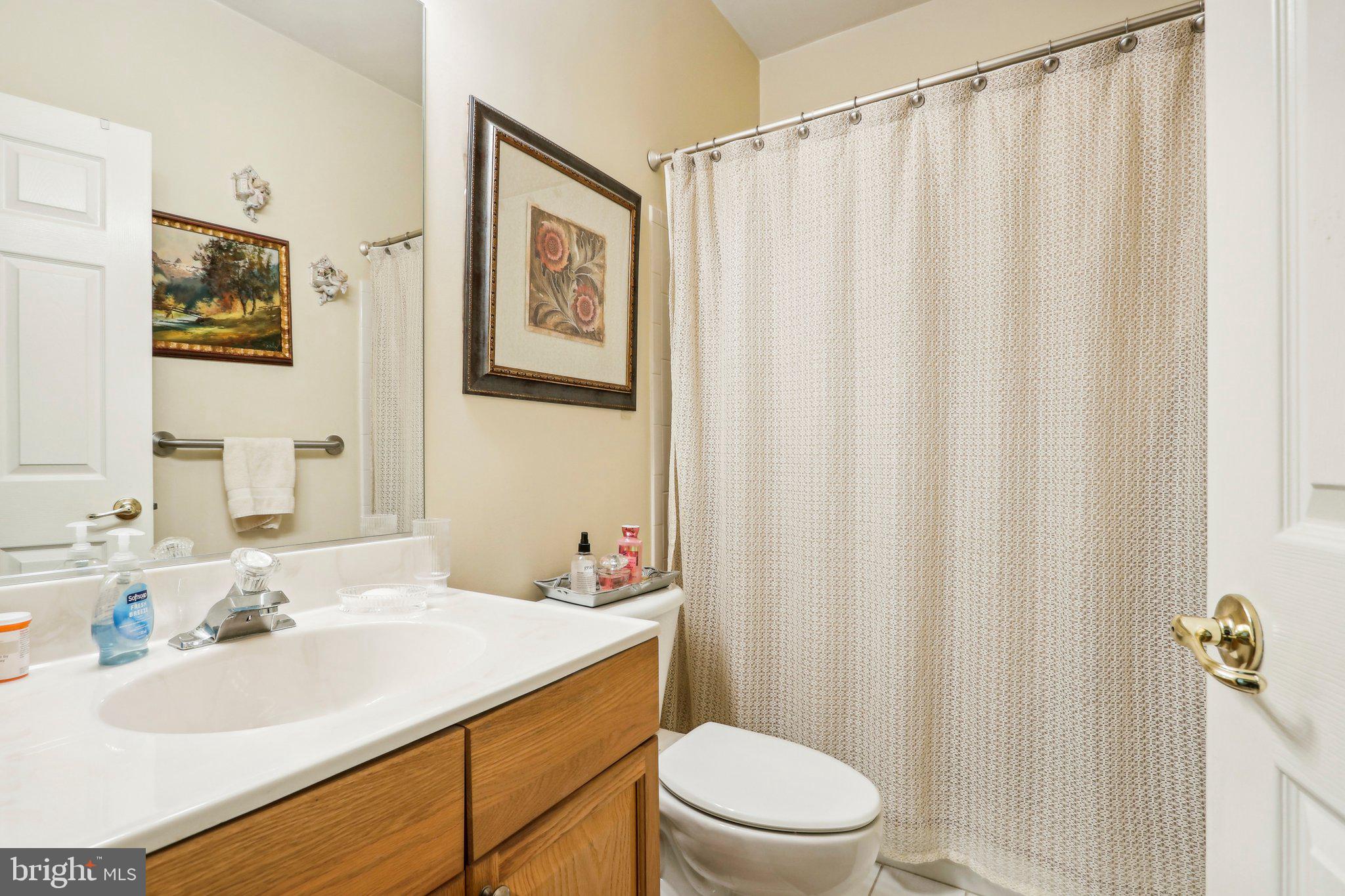 113 Kyle Way Ewing, NJ 08628 - Photo 25 of 42 a bathroom with a sink a toilet and shower curtain