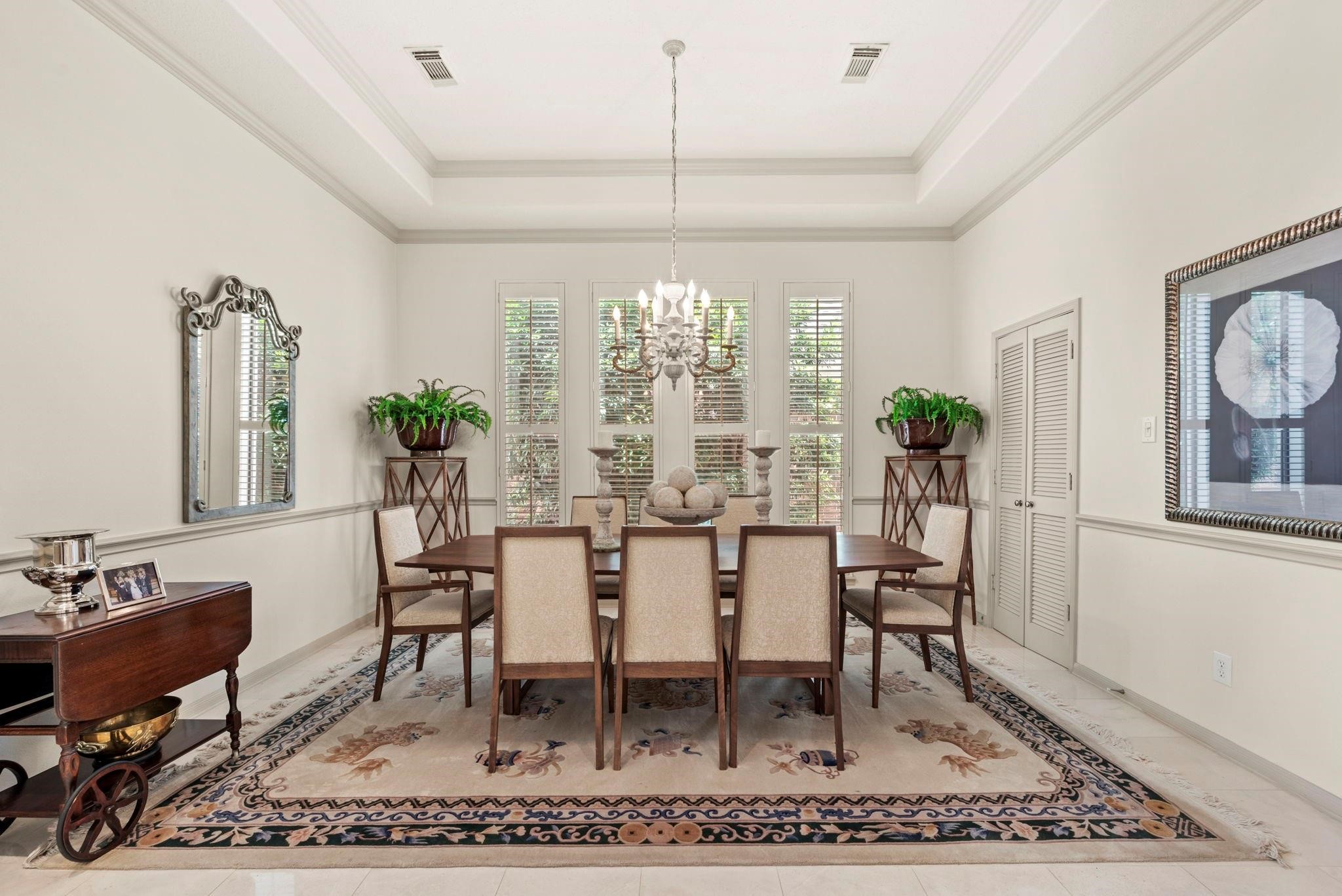 4513 Country Club View Baytown, TX 77521 - Photo 16 of 46 a dining room with furniture a rug and a chandelier