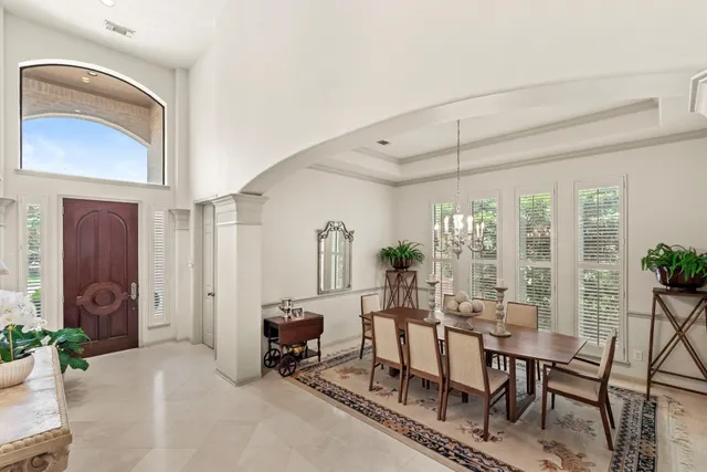 a living room with furniture a rug and white walls