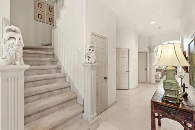 a bedroom with a bed a chandelier and a mirror