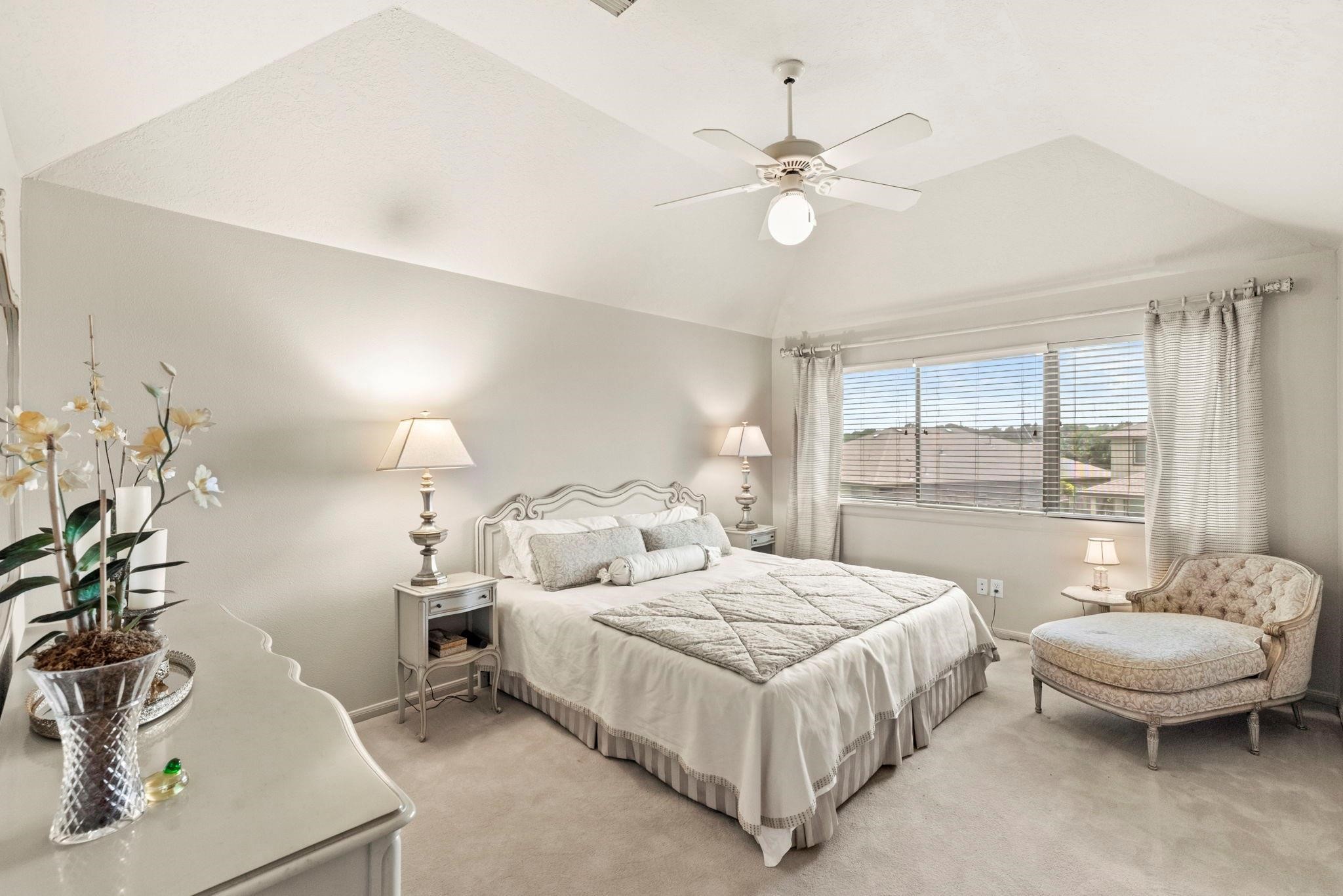 4513 Country Club View Baytown, TX 77521 - Photo 32 of 46 a bedroom with a bed a chandelier and a mirror