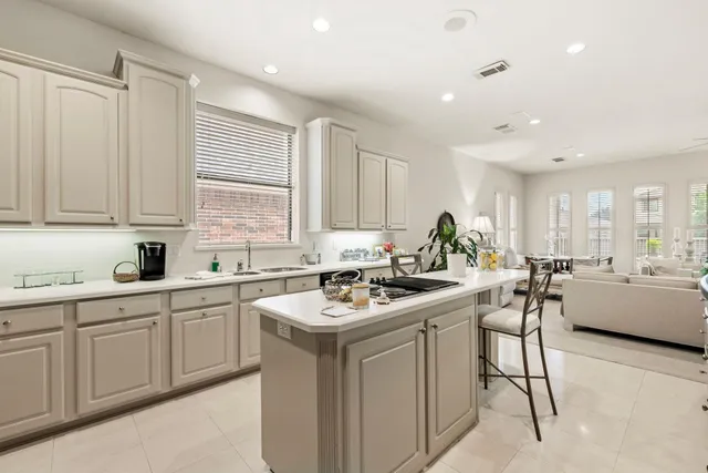 a kitchen with a sink a refrigerator and cabinets