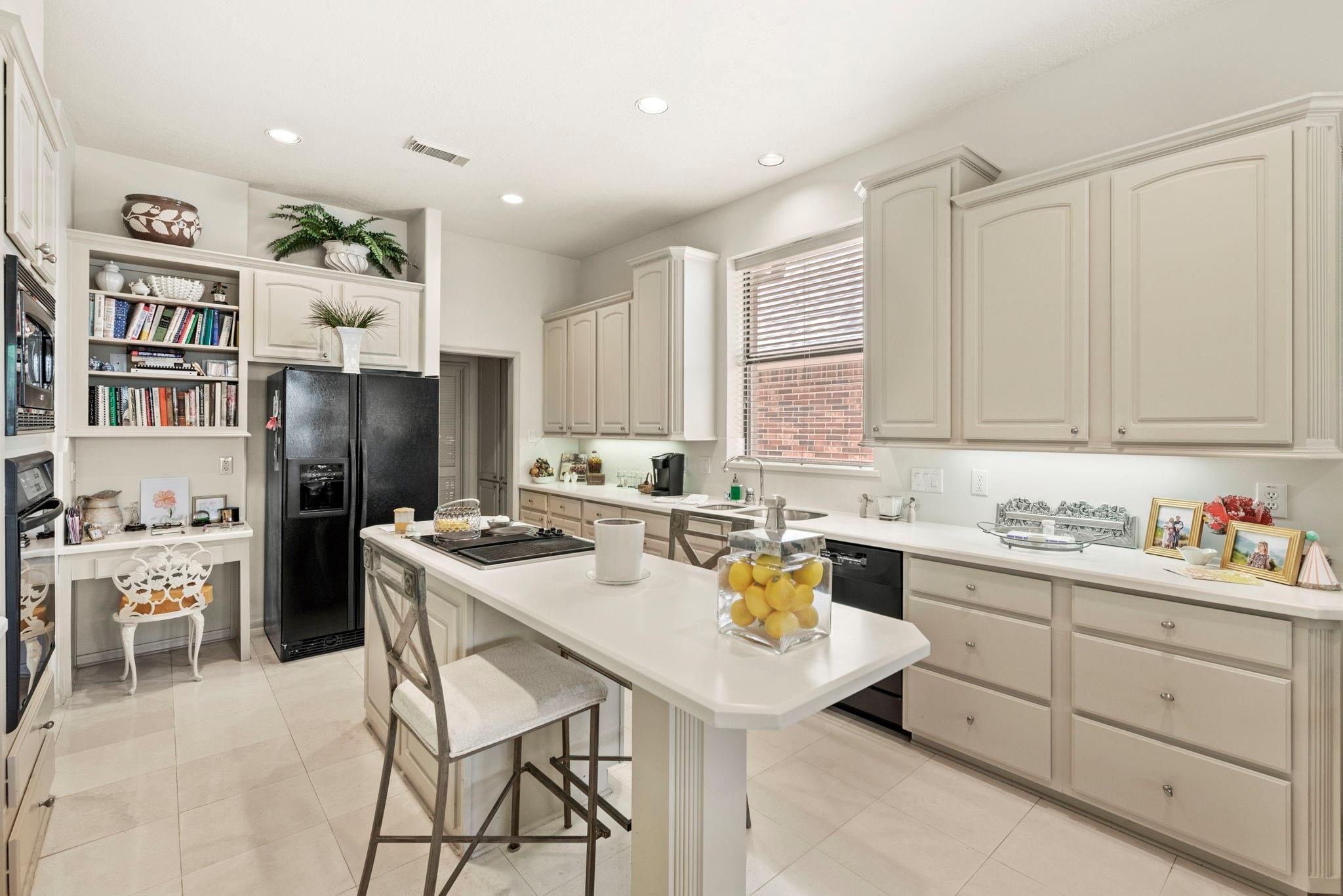 4513 Country Club View Baytown, TX 77521 - Photo 9 of 46 a kitchen with a sink a refrigerator and cabinets