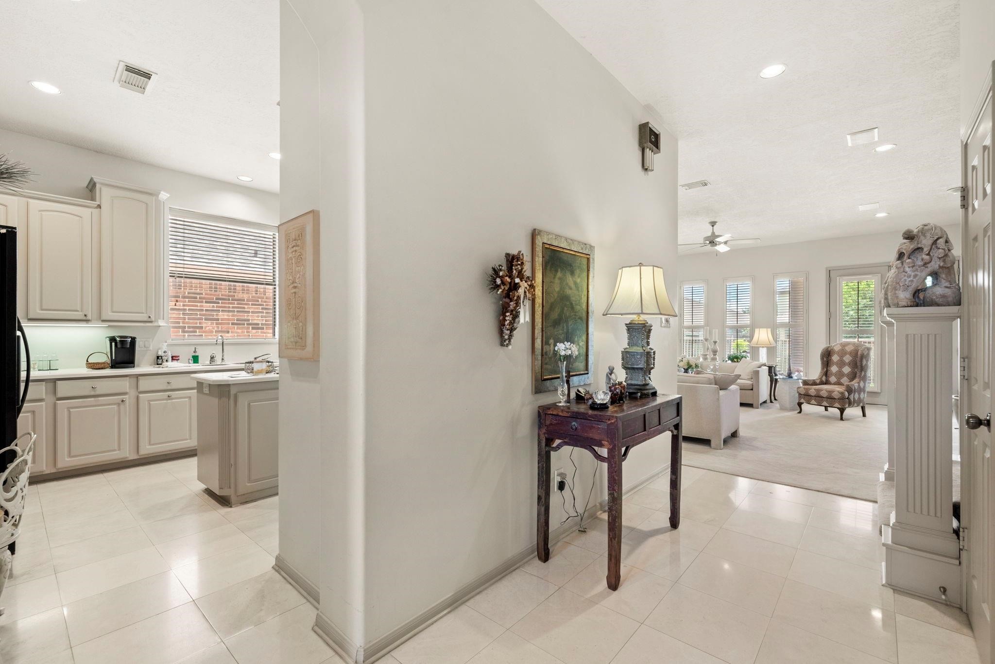 4513 Country Club View Baytown, TX 77521 - Photo 10 of 46 a kitchen with a refrigerator and white cabinets