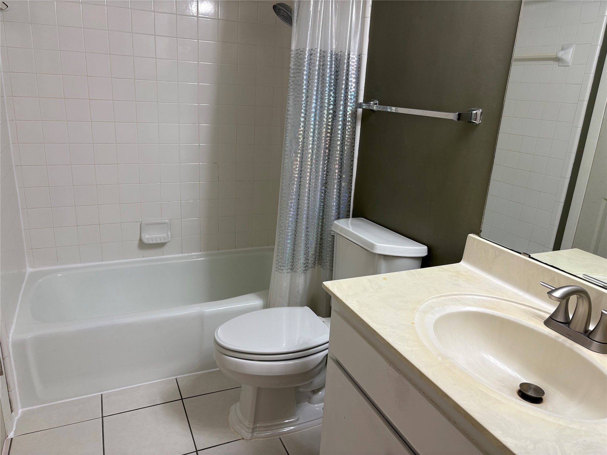 9226 Jollyville Road, Unit 144 Austin, TX 78759 - Photo 19 of 40 Bathroom featuring tile floors, vanity, and shower / bath combo with shower curtain