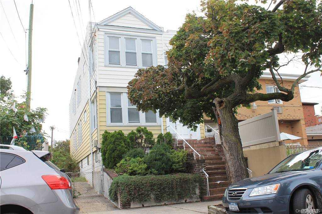 59-12 71st Street Queens, NY 11378 - Photo 1 of 26 a front view of a residential apartment building with a yard