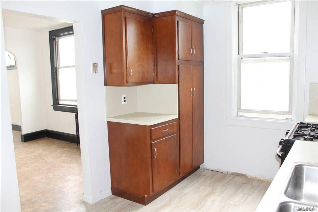 59-12 71st Street Queens, NY 11378 - Photo 11 of 26 a bathroom with a sink and a mirror