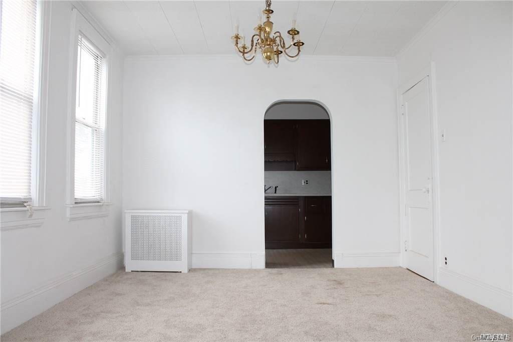 59-12 71st Street Queens, NY 11378 - Photo 18 of 26 an empty room with windows