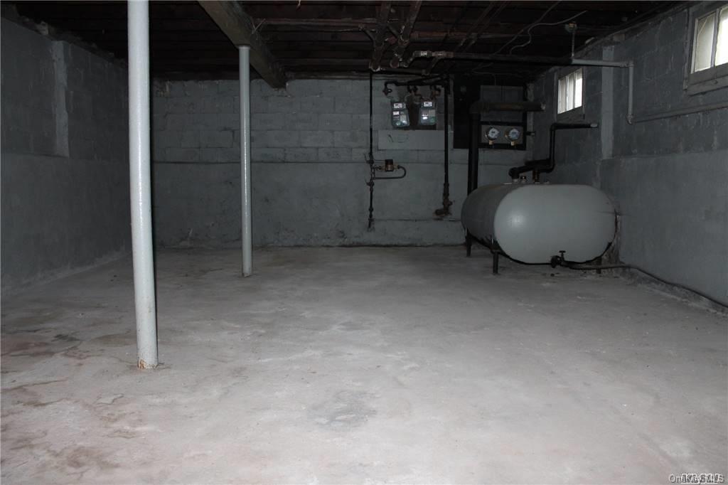 59-12 71st Street Queens, NY 11378 - Photo 26 of 26 a view of an empty room with wooden floor