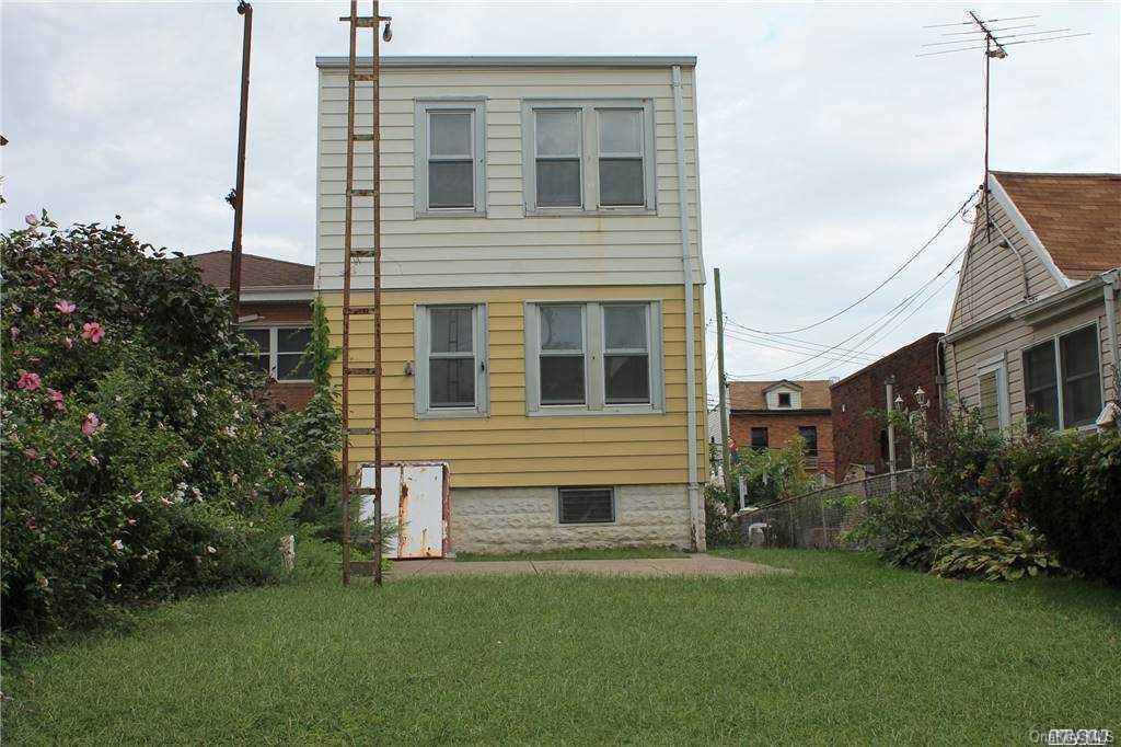 59-12 71st Street Queens, NY 11378 - Photo 3 of 26 a house view with a garden space