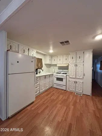 a kitchen with stainless steel appliances granite countertop a refrigerator sink and cabinets