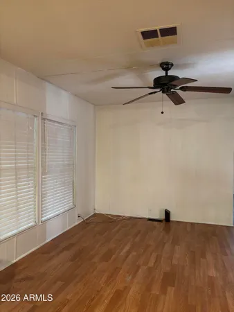 a view of empty room with wooden floor