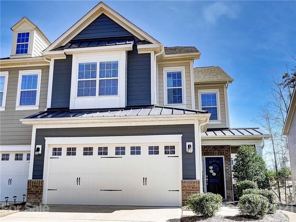 237 Butterfly Place, Unit 198 Tega Cay, SC 29708 - Photo 2 of 26 a front view of a building with many windows