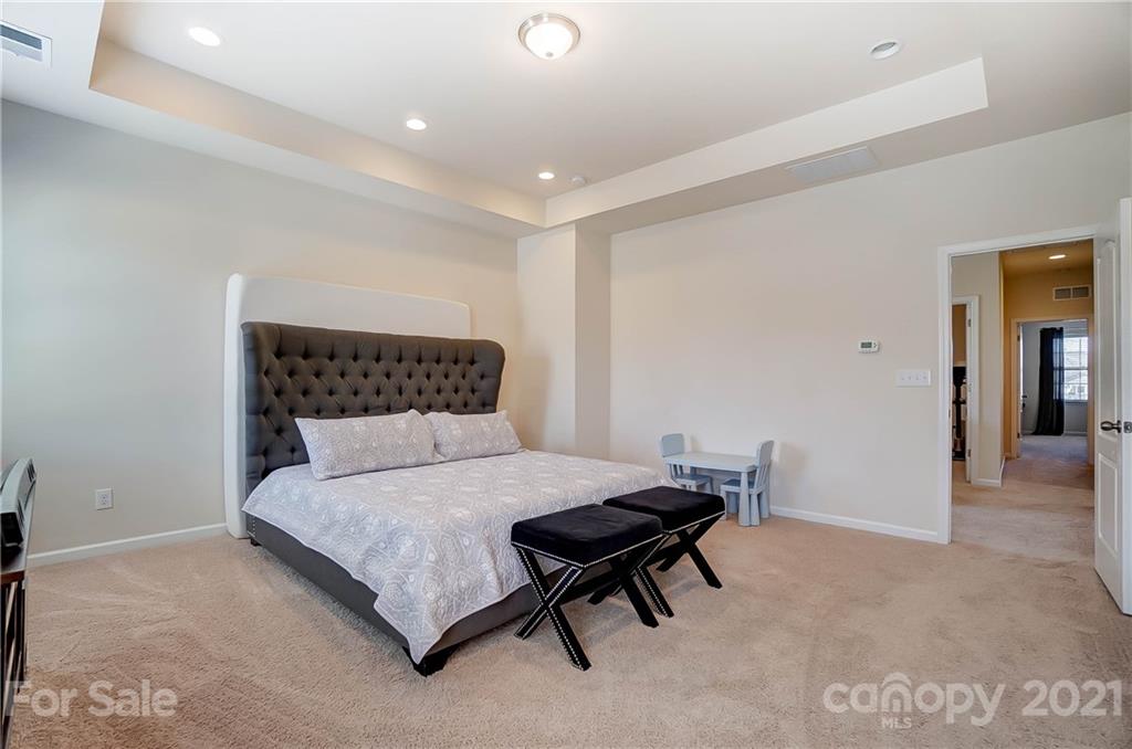 237 Butterfly Place, Unit 198 Tega Cay, SC 29708 - Photo 17 of 26 a bedroom with a bed and a table