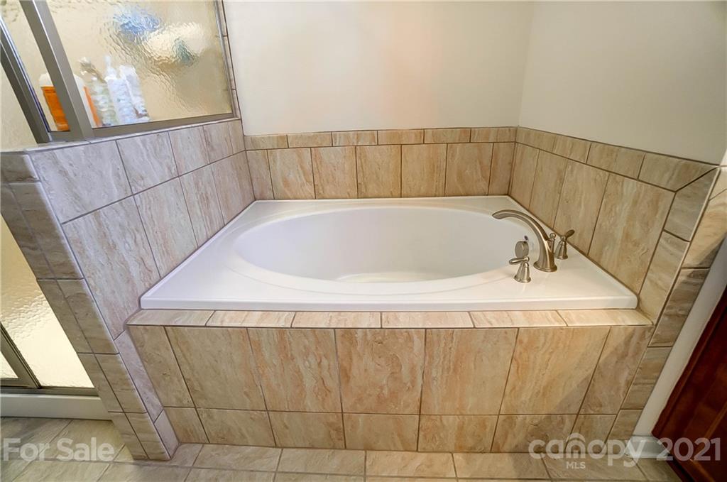 237 Butterfly Place, Unit 198 Tega Cay, SC 29708 - Photo 19 of 26 a bathroom with a bathtub