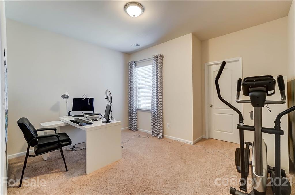 237 Butterfly Place, Unit 198 Tega Cay, SC 29708 - Photo 22 of 26 a view of a workspace with furniture and a window
