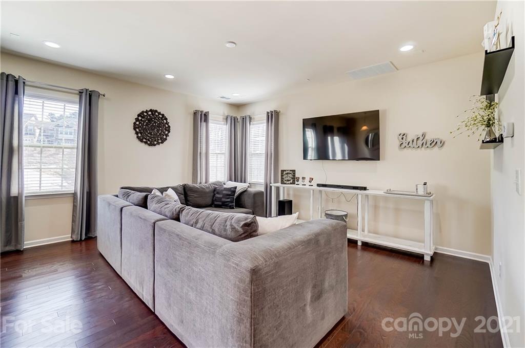 237 Butterfly Place, Unit 198 Tega Cay, SC 29708 - Photo 5 of 26 a living room with furniture and a flat screen tv