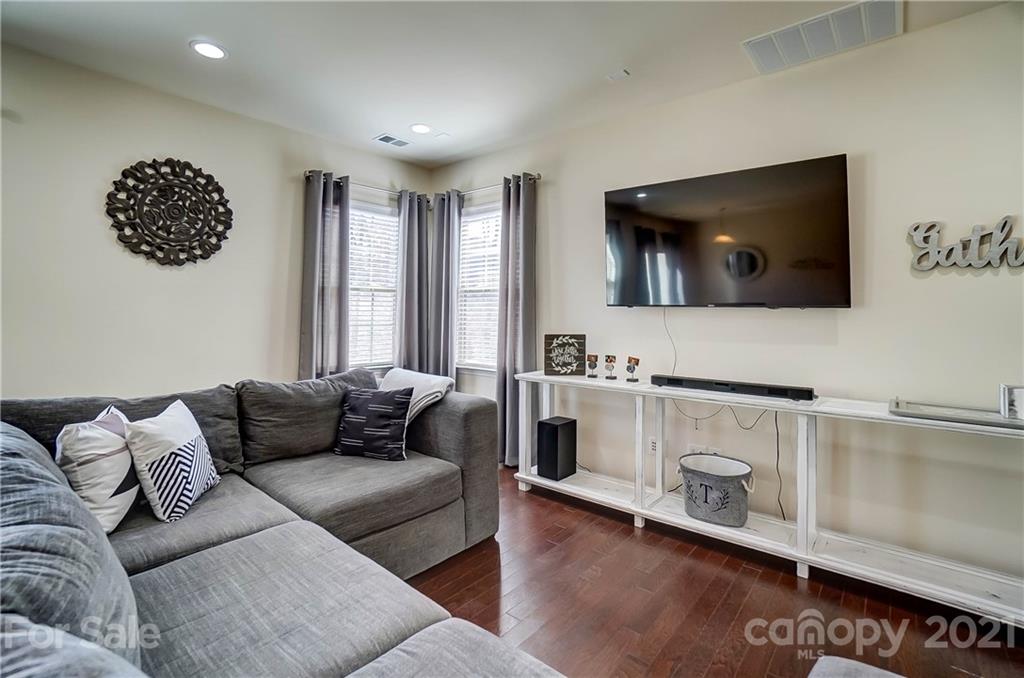 237 Butterfly Place, Unit 198 Tega Cay, SC 29708 - Photo 6 of 26 a living room with furniture and a flat screen tv