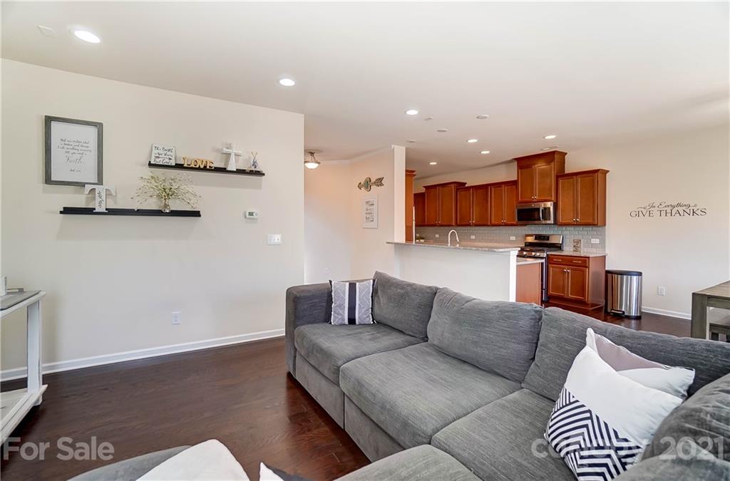 237 Butterfly Place, Unit 198 Tega Cay, SC 29708 - Photo 9 of 26 a living room with furniture and kitchen view