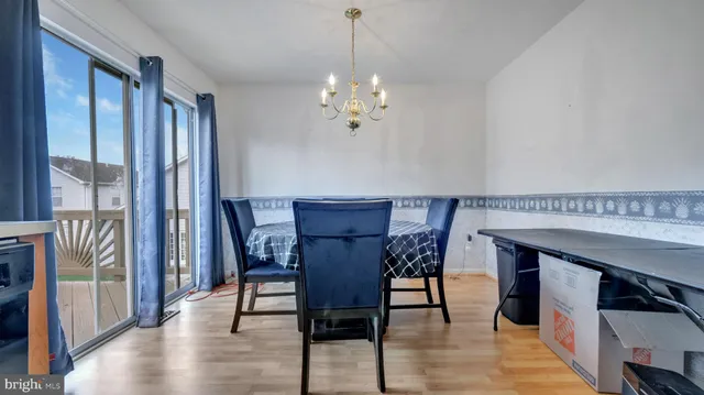 a view of a a dining room with furniture window and wooden floor