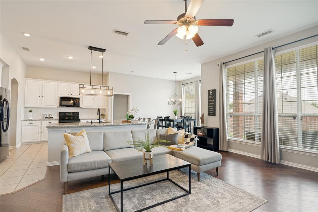 6305 Timbercrest Trail Sachse, TX 75048 - Photo 1 of 1 a living room with furniture a large window and a chandelier