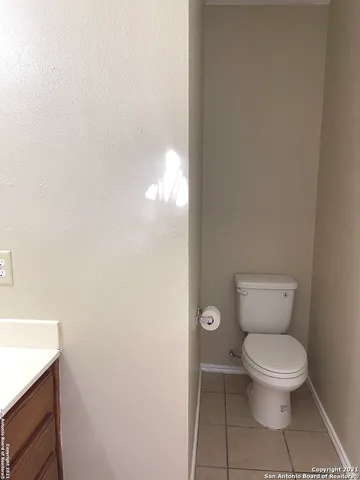 a white toilet sitting next to a white sink