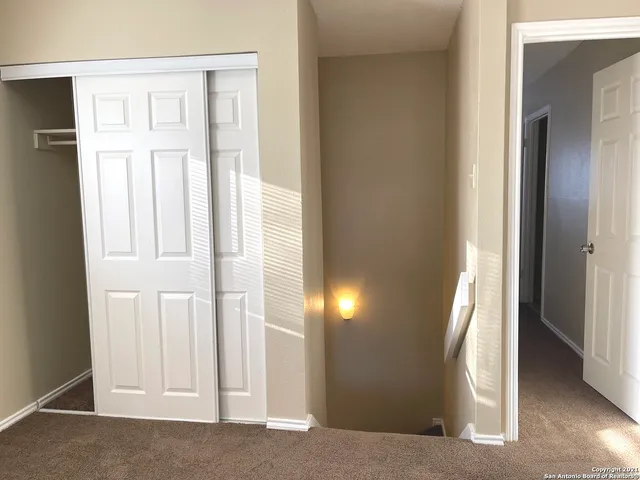 a view of a hallway with wooden floor and entryway