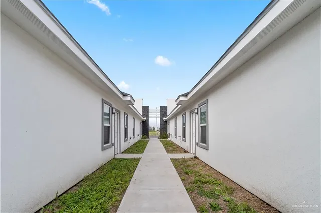 a view of a pathway both side of house