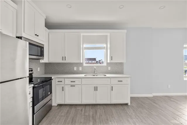 a kitchen with a sink stove and cabinets