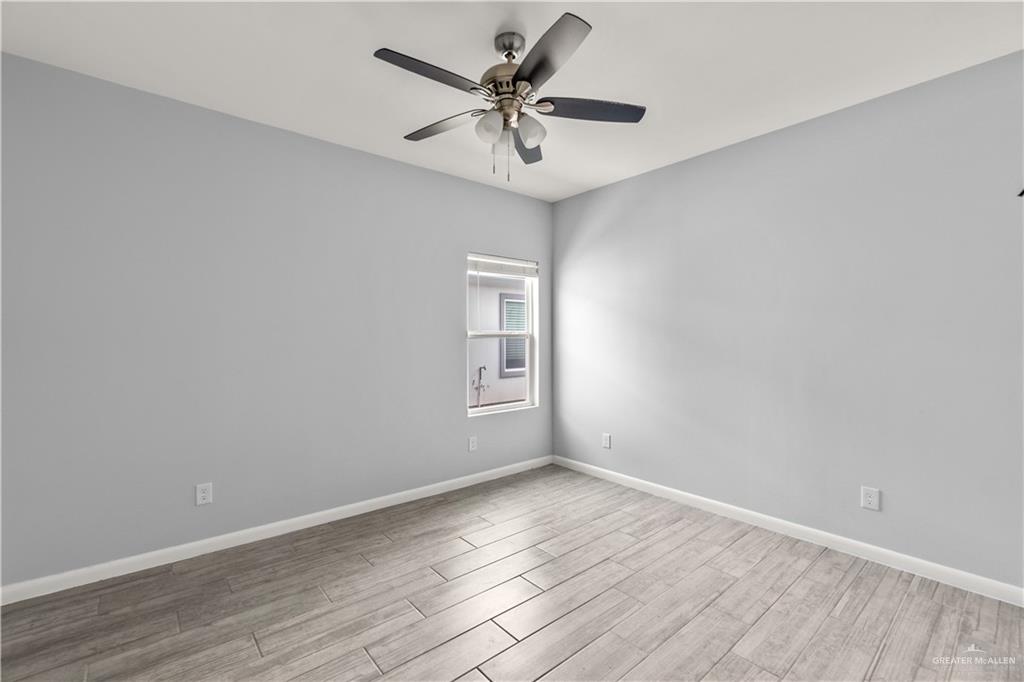 11018 North 33rd Lane, Unit 2 McAllen, TX 78504 - Photo 10 of 17 wooden floor in an empty room