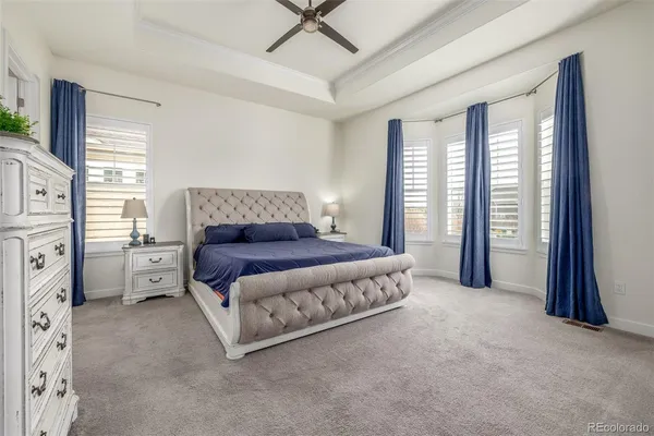a spacious bedroom with a bed and a window