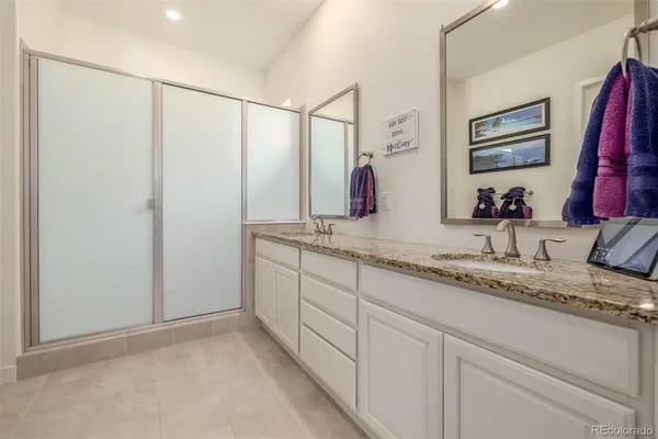 a bathroom with a double vanity sink and a mirror