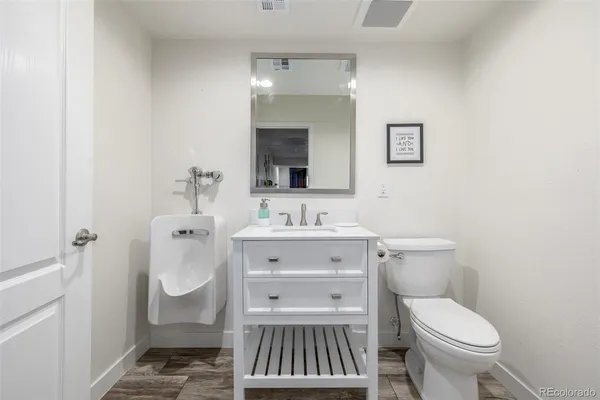 a bathroom with a sink toilet and mirror