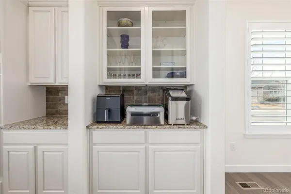 a kitchen with a refrigerator and a sink