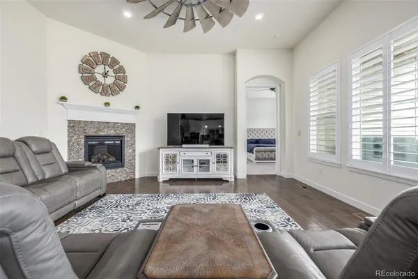 a living room with furniture a fireplace and a flat screen tv