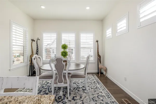a view of a dining room with furniture and wooden floor