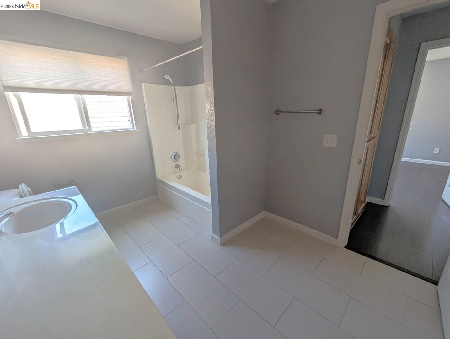 4958 Bay View Circle Stockton, CA 95219 - Photo 12 of 24 full bath with vanity, light tile patterned floors, and washtub / shower combination