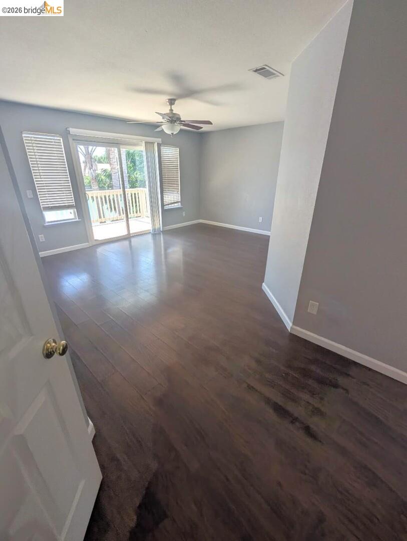 4958 Bay View Circle Stockton, CA 95219 - Photo 13 of 24 empty room featuring dark wood-type flooring and a ceiling fan