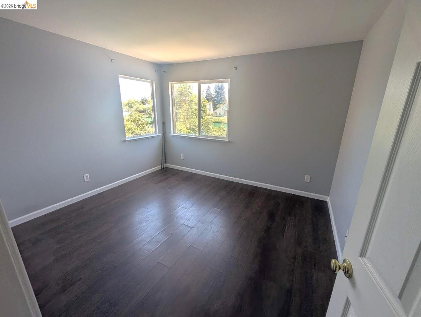 4958 Bay View Circle Stockton, CA 95219 - Photo 4 of 24 empty room with dark wood-style floors and baseboards