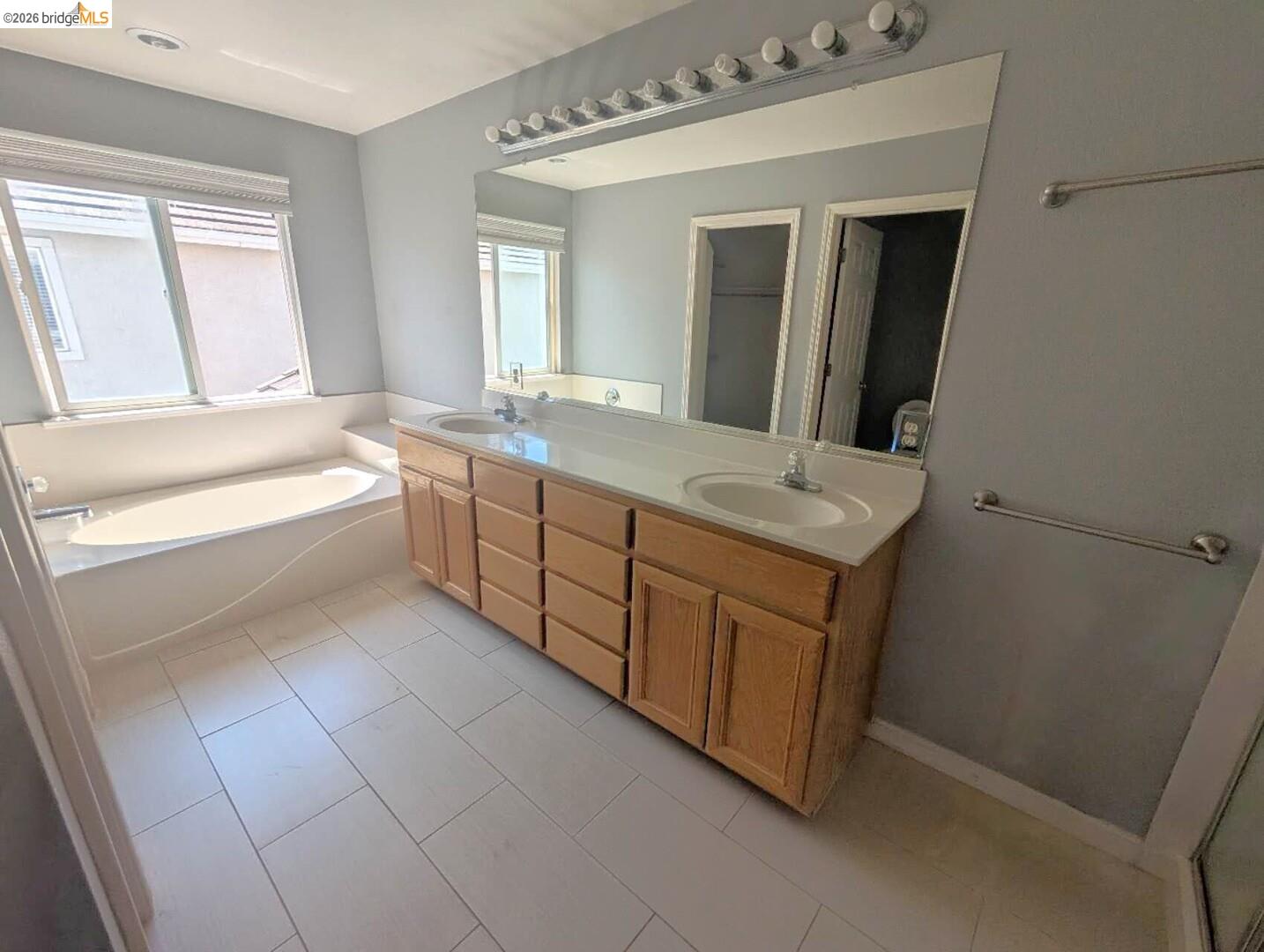 4958 Bay View Circle Stockton, CA 95219 - Photo 7 of 24 full bath featuring double vanity, a garden tub, and light tile patterned floors