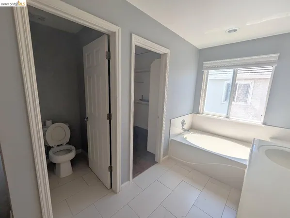 a spacious bathroom with a double vanity sink and a mirror