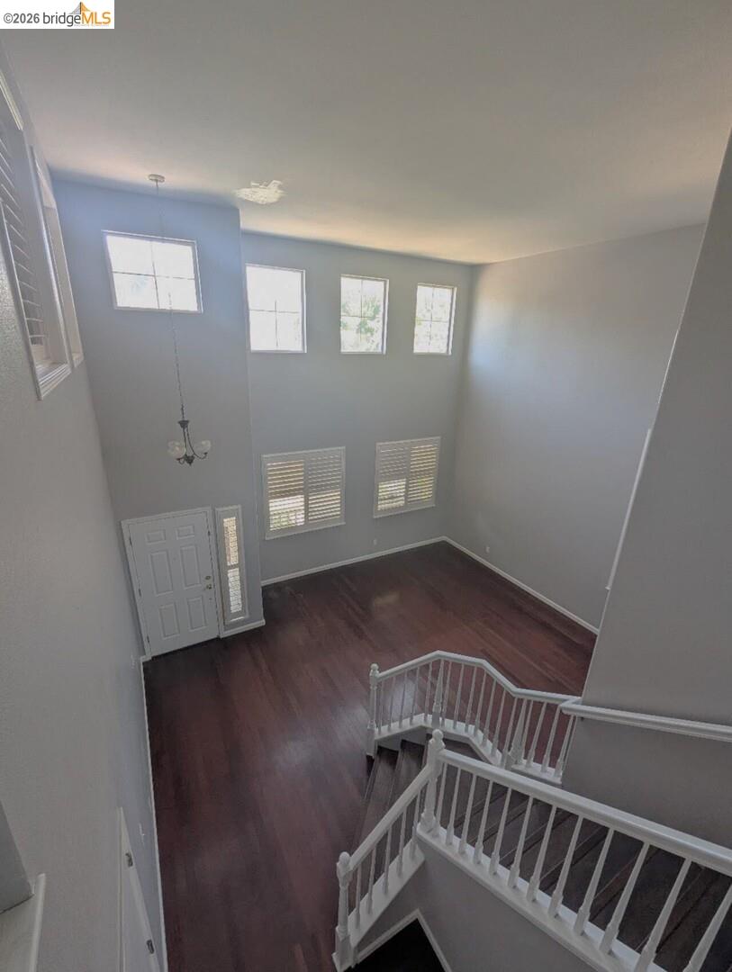 4958 Bay View Circle Stockton, CA 95219 - Photo 8 of 24 stairway with wood finished floors, healthy amount of natural light, and a high ceiling