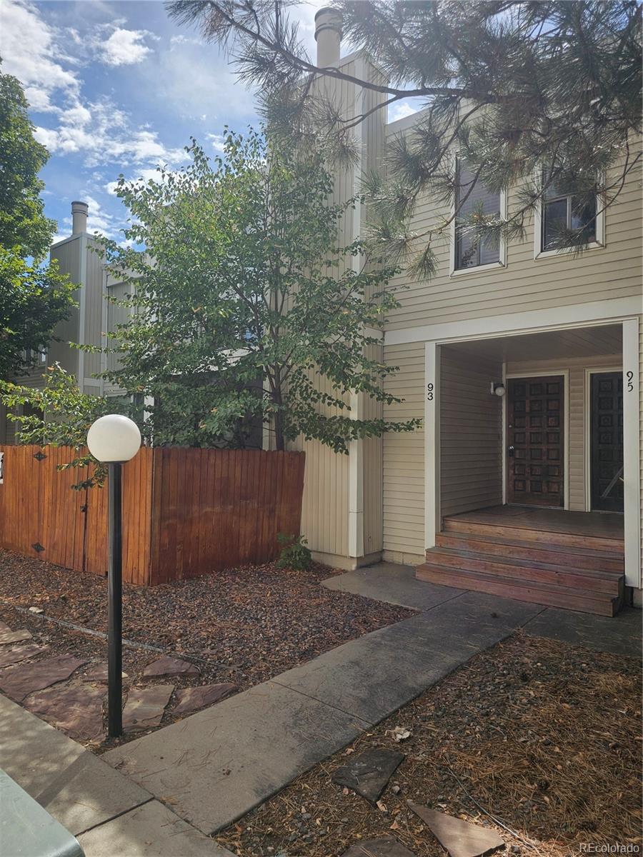 1050 South Monaco Parkway, Unit 93 Denver, CO 80224 - Photo 1 of 20 a front view of a house with trees