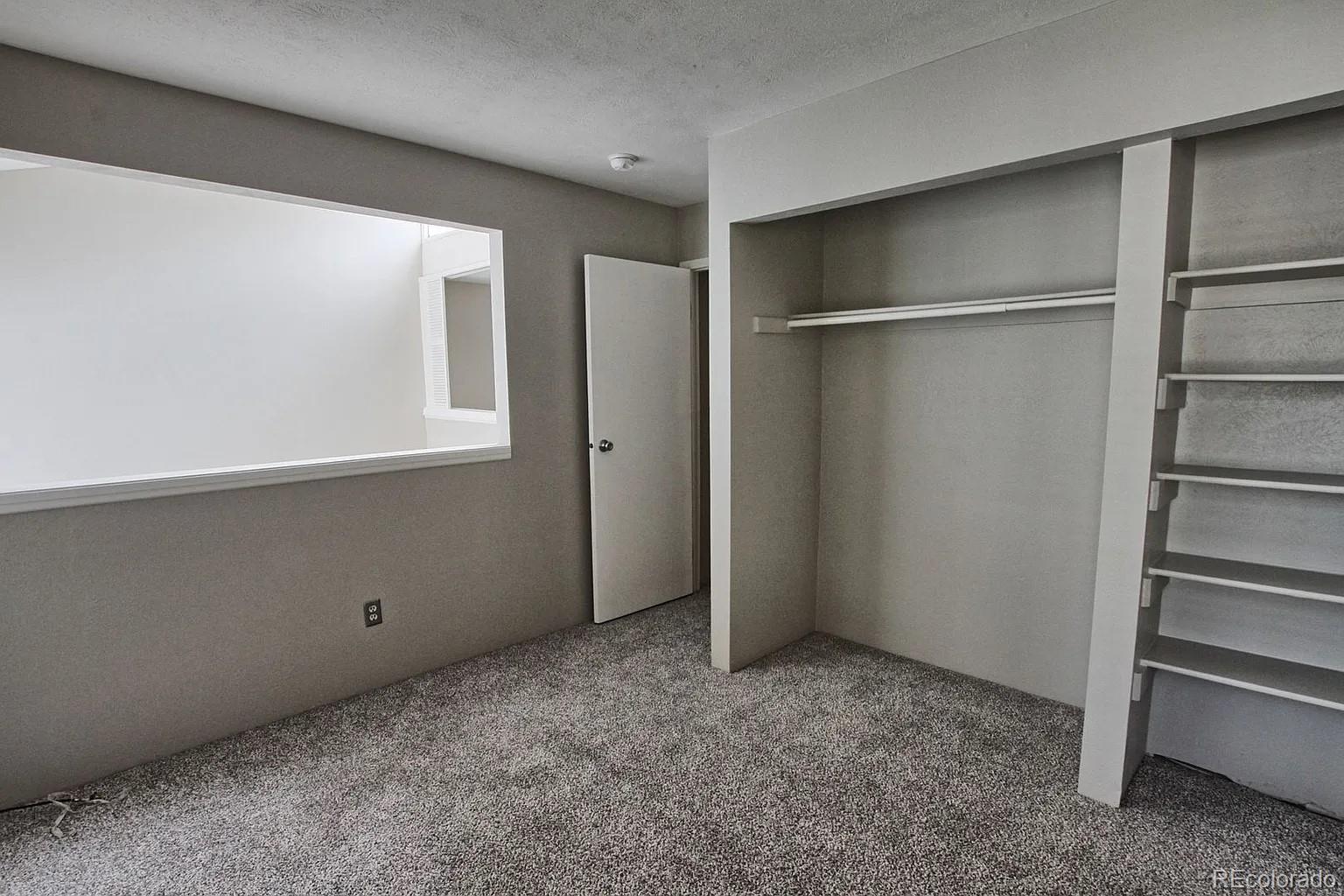 1050 South Monaco Parkway, Unit 93 Denver, CO 80224 - Photo 11 of 20 a view of an empty room with a window