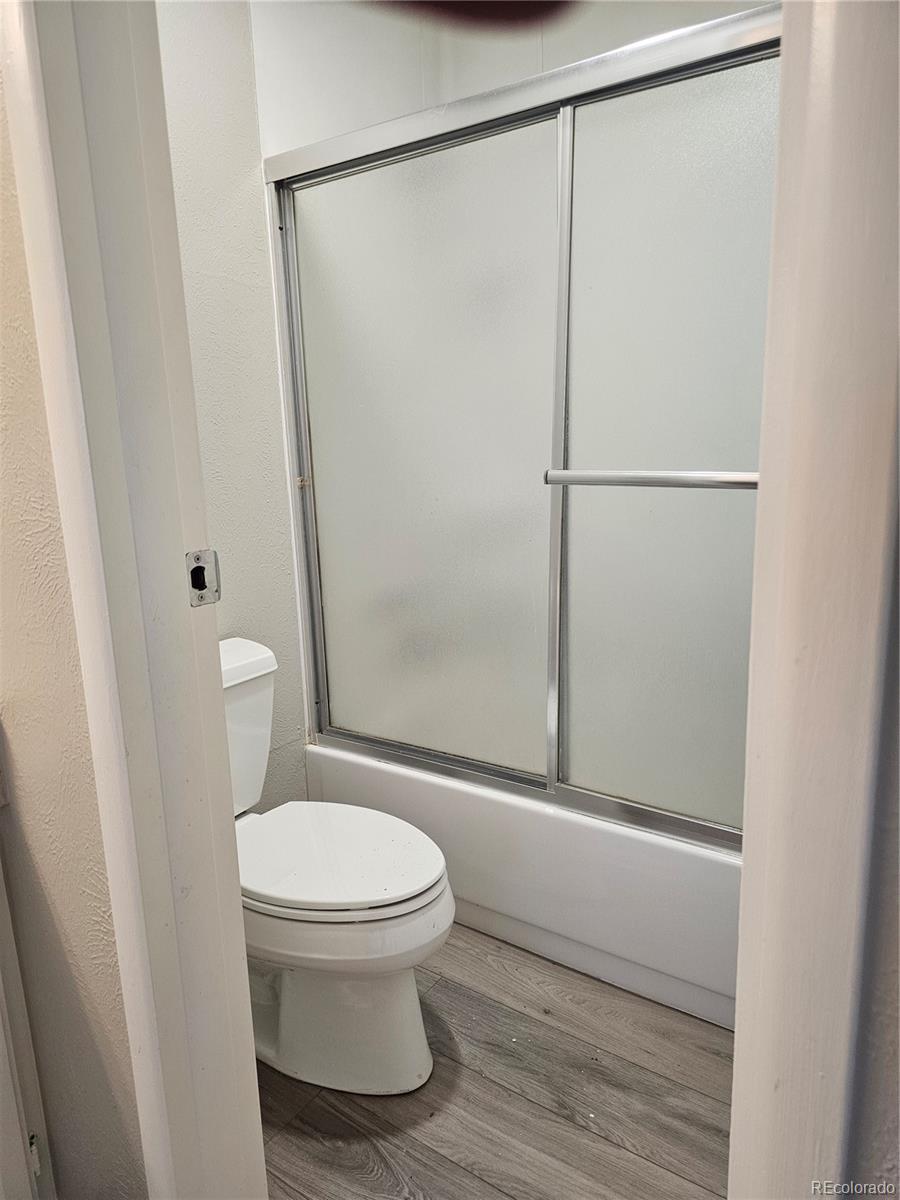 1050 South Monaco Parkway, Unit 93 Denver, CO 80224 - Photo 15 of 20 a white toilet sitting next to a shower